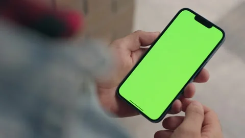 Man Using Green Mock-up Screen Phone Outdoors. Chroma Key Display On Smartphone Stock Footage 252585280