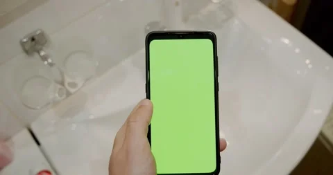 Man Using green screen Cellphone in Bathroom. V2 Stock Footage 136558724