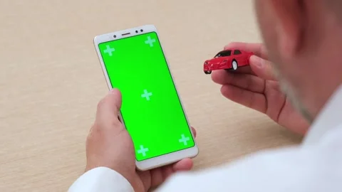 Man using green screen chroma key phone and holding red car model Stock-Footage 274216061
