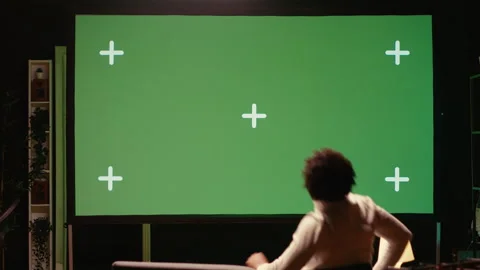 Man using green screen modern TV to watch news program broadcasting in living Stock Footage 262012429