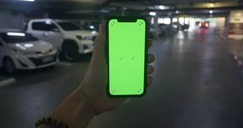 Man using green screen phone app on touchscreen of smartphone call taxi view Stock Footage 246337444