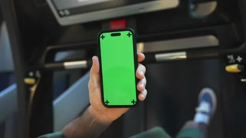 Man using green screen phone on running track. Close up Stock Footage 264965919