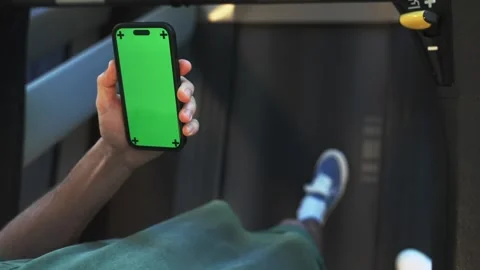 Man using green screen phone on running track. Close up Stock Footage 265134541