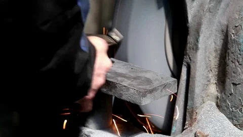 A man using a grinder to carve metal part Stock-Footage 76856896