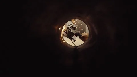 Man using a grinding machine in a pipe. Sparks, heavy industry workers. Stock Footage 246606719