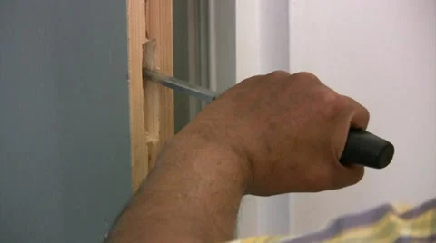 Man using hammer and chisel on a wooden door Video stock 30622462