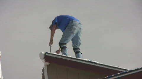 Man Using Hammer and Wrecking Bar On Roof Stock Footage 624250