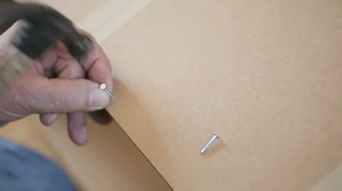Man using hammer on bookcase  assembly DIY Stock Footage 47784055