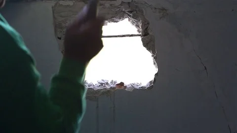Man using hammer on wall. Stock Footage 77330433