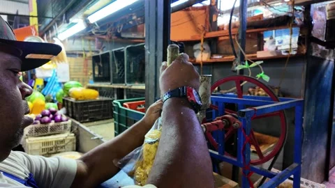 Man using a hand-cranked machine to grind corn. Basic ingredient in Latin Video stock 312030657