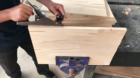 Man using hand planer on a rubber wood  Stock Footage 106440989