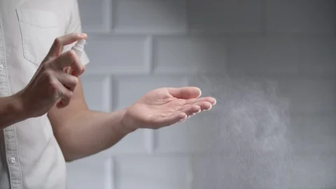 Man using hand sanitizer alcohol spray Stock Footage 126302102