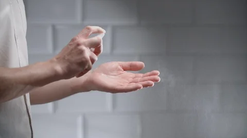 Man using hand sanitizer alcohol spray Stock Footage 126302106