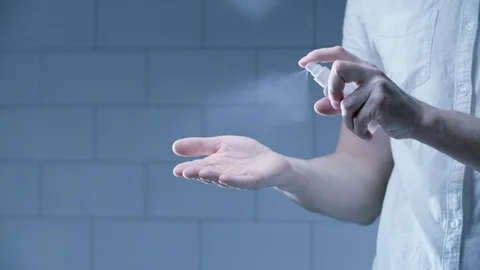 Man using hand sanitizer alcohol spray Stock Footage 126302109