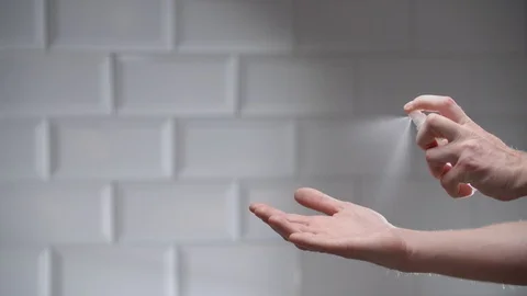 Man using hand sanitizer alcohol spray Stock Footage 126302128