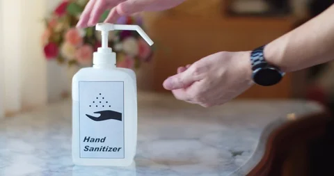 Man using hand sanitizer to clean his hands Stock Footage 128409606