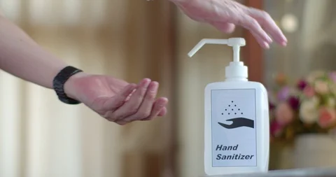 Man using hand sanitizer to clean his hands Stock Footage 128409689