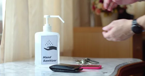 Man using hand sanitizer to clean his hands Stock Footage 128409889