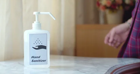 Man using hand sanitizer to clean his hands Stock Footage 128409907