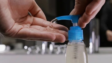 Man using hand sanitizer gel to prevent spreading corona virus. Stock-Footage 127120104