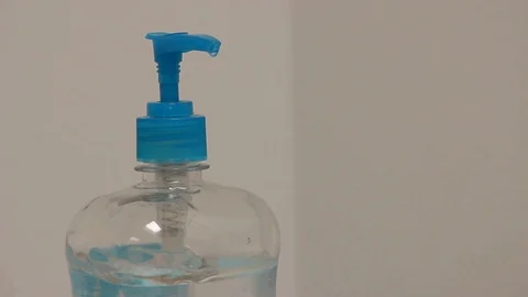 Man using hand-sanitizer in an office Stock Footage 92525244