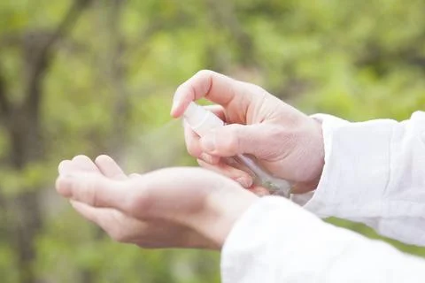 Man using hand sanitizer Stock Photos