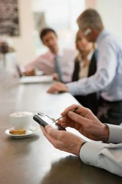 Man using handheld computer at bar counter Stock Photos