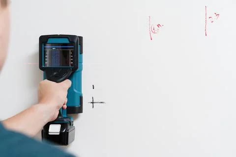 Man Using Handheld Electronic Stud Finder Stock Photos