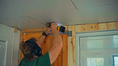 Man Using Handheld Power Drill Doing A DIY Renovation Stock Footage 336705862
