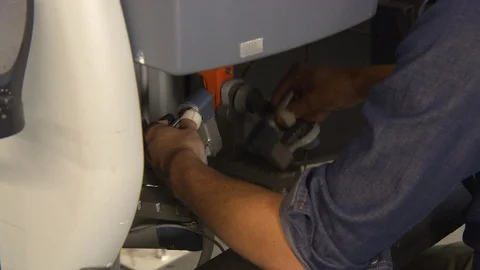 Man using handles to direct robotic hands Video stock 99051545