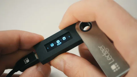 Man using a hardware wallet to manage his crypto currency Stock Footage 100463996