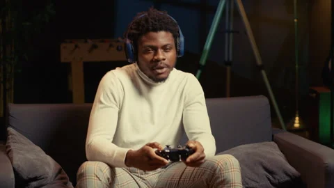 Man using headphones mic to talk with teammates while playing videogame Stock Footage 262012395