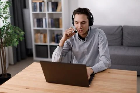 Man using headset and laptop Foto stock