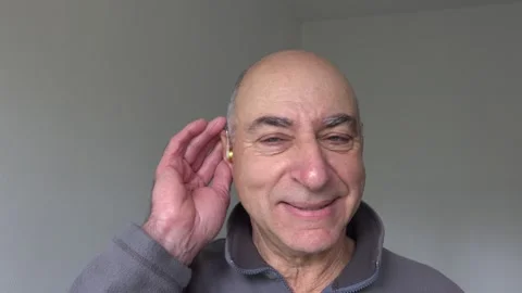 A man is using a hearing aid asks to speak louder Stock Footage 330692646