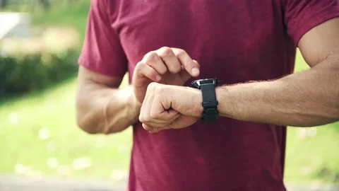 Man using high tech smart watch in park. Stock Footage 92476335