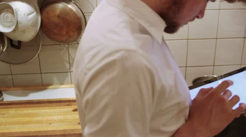 A man is using his iPad in the the kitchen Stock Footage 40356972