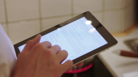 A man is using his iPad in the the kitchen Stock Footage 40356973