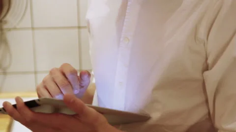 A man is using his iPad in the the kitchen Stock Footage 40357021