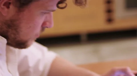A man is using his iPad in the the kitchen Stock Footage 40357267