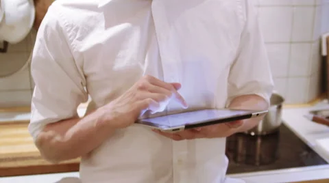 A man is using his iPad in the the kitchen Stock Footage 40357278