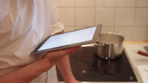 A man is using his iPad in the the kitchen Stock Footage 40357569