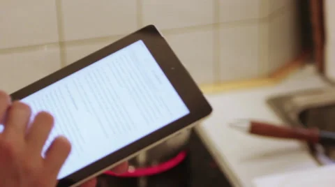A man is using his iPad in the the kitchen Stock Footage 40357631