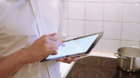 A man is using his iPad in the the kitchen Stock Footage 40357828