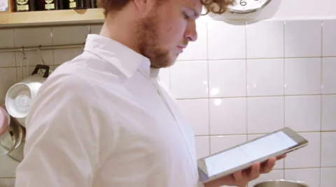 A man is using his iPad in the the kitchen Stock Footage 40358028