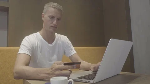 Man using his laptop and a credit card Stock Footage 88589002