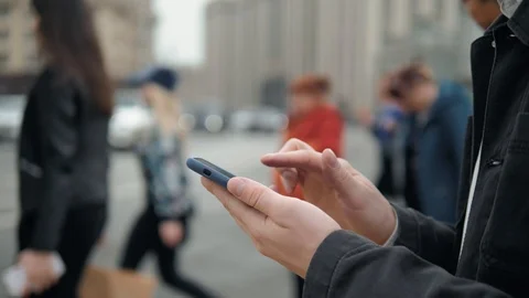Man using his Mobile Phone outdoor, close up, man walking with cell phone on Stock Footage
