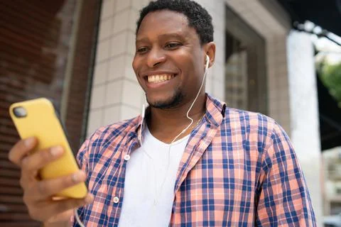 Man using his mobile phone on the street. Stock Photos