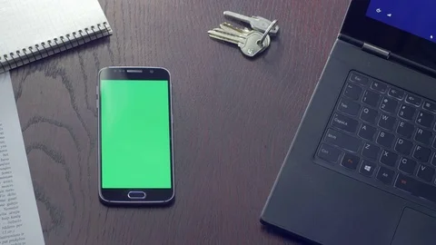 Man using his phone with green screen in a workplace Stock Footage 75460396