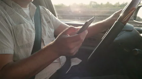 Man Using his Phone While Driving Stock Footage 64877330