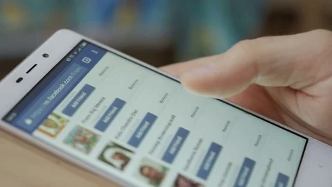 Man using his smartphone with to scroll a Facebook account feed, scrolling ne Stock Footage